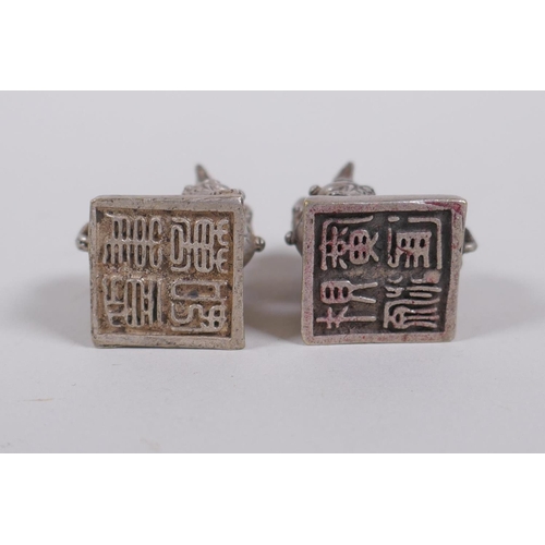 30 - A pair of Chinese white metal seals with Fo dog knops, 3cm high