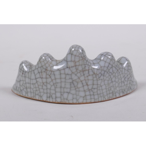 304 - A Chinese celadon crackle glazed porcelain brush rest, 12cm wide