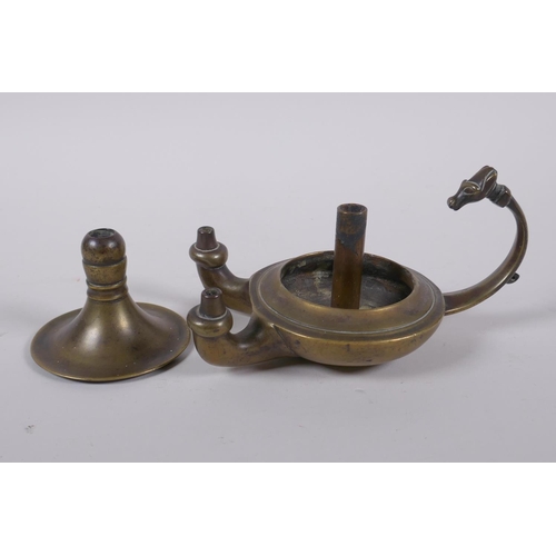 37 - An antique brass twin spout whale oil lamp with animal mask decoration to handle, 15cm long