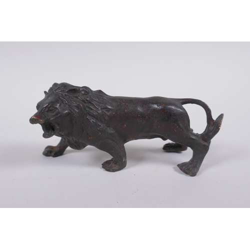 41 - A bronzed and gilt metal lion, 14cm long