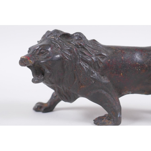 41 - A bronzed and gilt metal lion, 14cm long