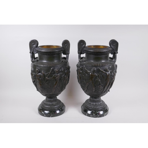 5 - A pair of Grand Tour bronze urns on marble bases, decorated with Greco Roman figures, 41cm high