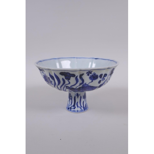 58 - A blue and white porcelain stem bowl of lobed form, decorated with carp in a lotus pond, Chinese Xua... 