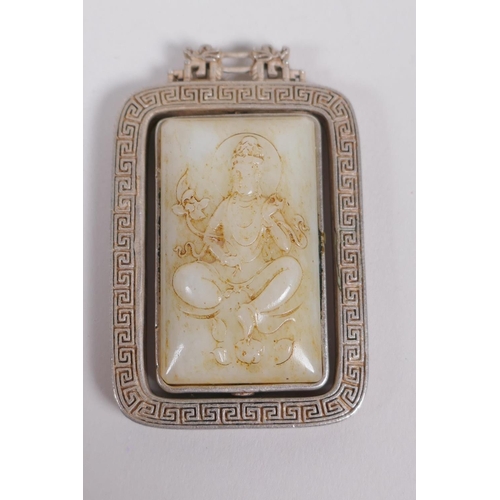 60 - A Chinese white metal and jade set pendant with revolving panel depicting buddha, 6cm x 4cm