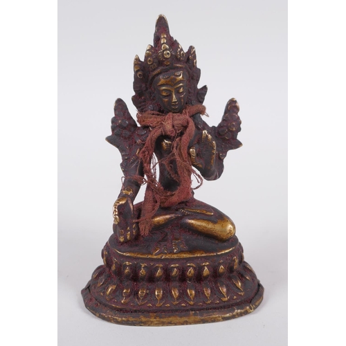 61 - A Tibetan bronze figure of Buddha seated on a lotus throne, 10cm high