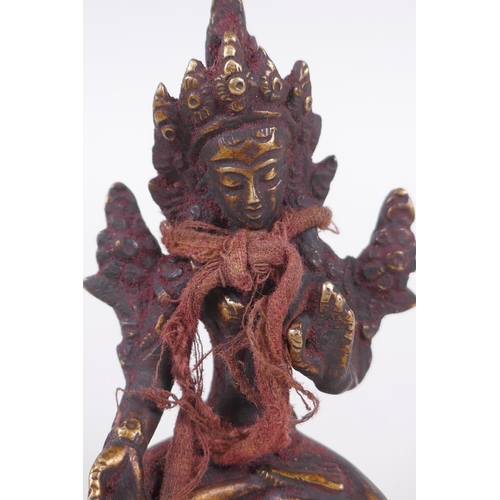 61 - A Tibetan bronze figure of Buddha seated on a lotus throne, 10cm high