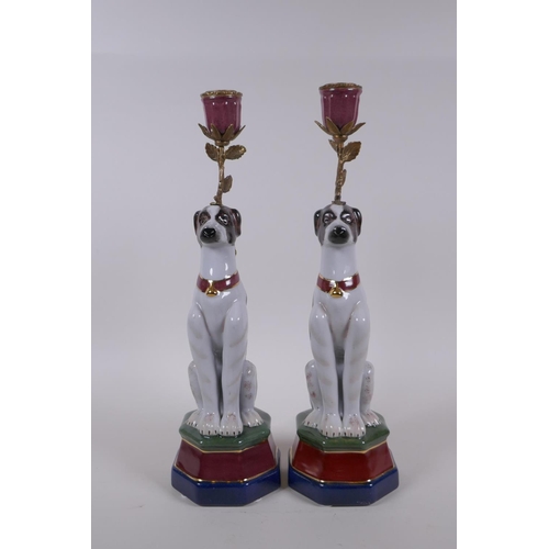 62 - A pair of polychrome porcelain and gilt metal candlesticks in the form of dogs, 34cm high