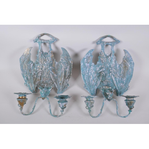 64 - A pair of gothic style bronze bat two branch sconces with extensive verdigris patina, 25 x 34cm