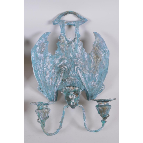 64 - A pair of gothic style bronze bat two branch sconces with extensive verdigris patina, 25 x 34cm