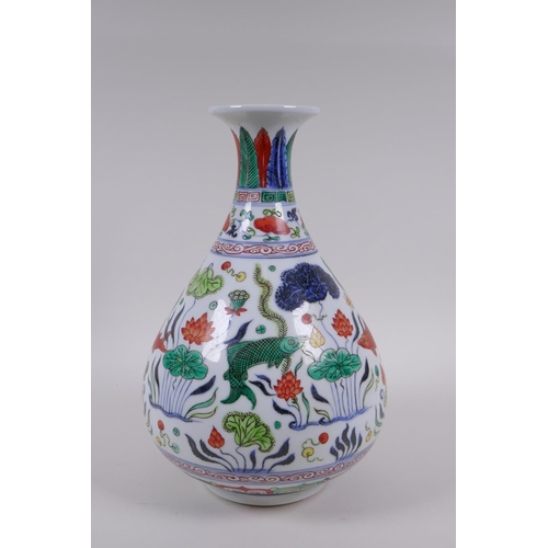 65 - A Chinese wucai porcelain pear shaped vase decorated with carp in a lotus pond, Xuande 6 character m... 