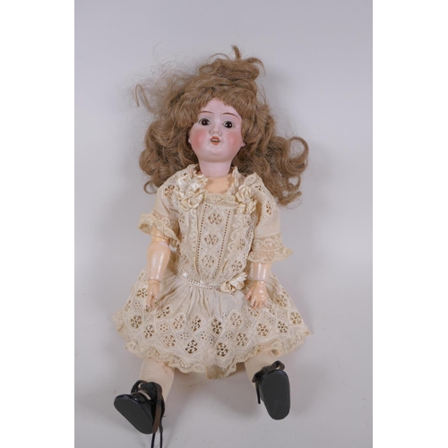 67 - An antique German Schoenau and Hoffmeister bisque headed doll in a white lace dress, marked S PB H 1... 