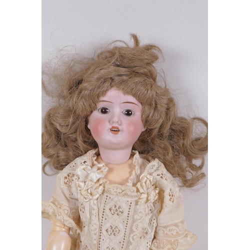 67 - An antique German Schoenau and Hoffmeister bisque headed doll in a white lace dress, marked S PB H 1... 