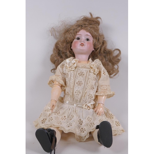 67 - An antique German Schoenau and Hoffmeister bisque headed doll in a white lace dress, marked S PB H 1... 