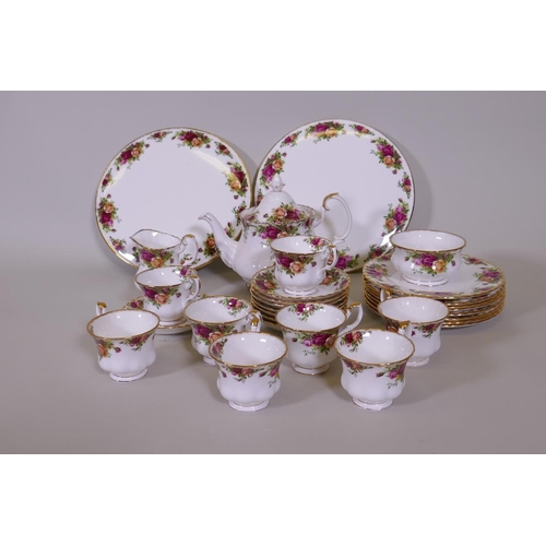 69 - A Royal Albert Country Rose eight place tea service with two serving plates