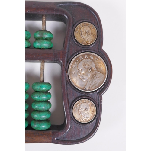 71 - A Chinese hardwood and malachite style stone abacus inset with white metal tokens, 41 x 15cm