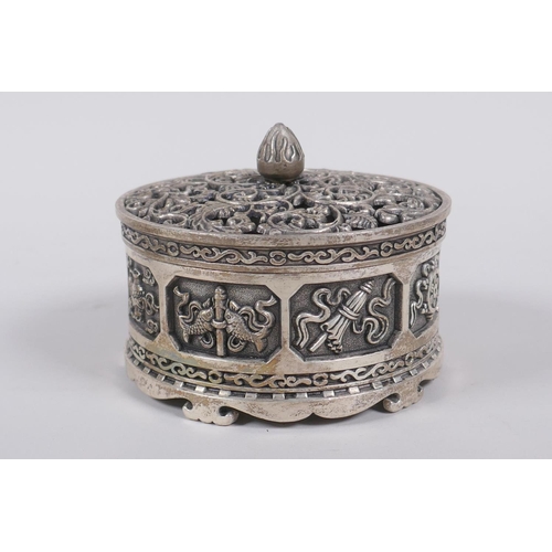 75 - A Sino Tibetan white metal cylinder censer and cover, decorated with the emblems of the eight immort... 