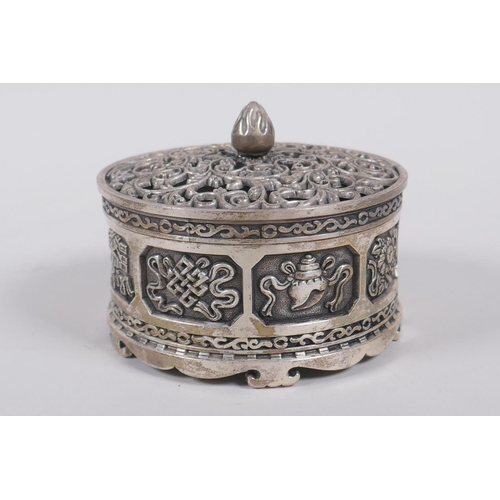 75 - A Sino Tibetan white metal cylinder censer and cover, decorated with the emblems of the eight immort... 