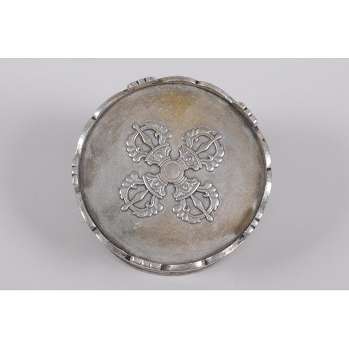 75 - A Sino Tibetan white metal cylinder censer and cover, decorated with the emblems of the eight immort... 