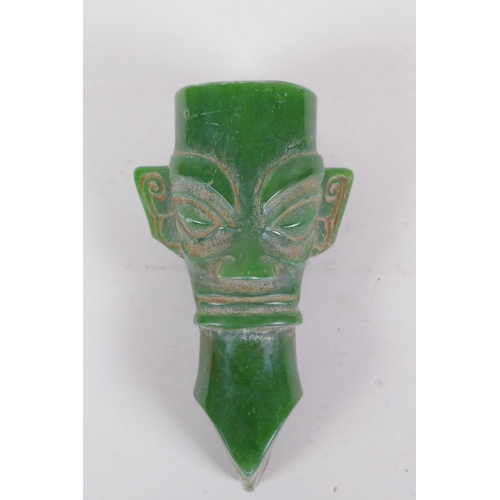 77 - An oriental reconstituted green hardstone archaic style head, 14cm