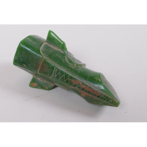 77 - An oriental reconstituted green hardstone archaic style head, 14cm