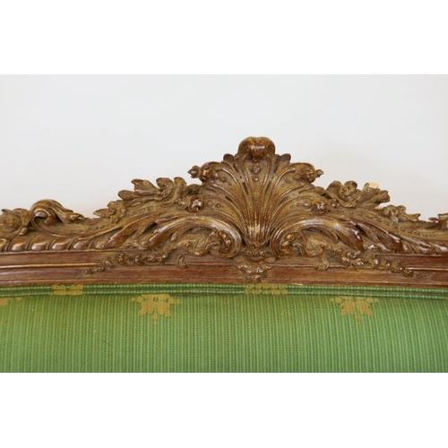 1059 - A C19th French style carved walnut settee, with shaped fronts, 180cm wide