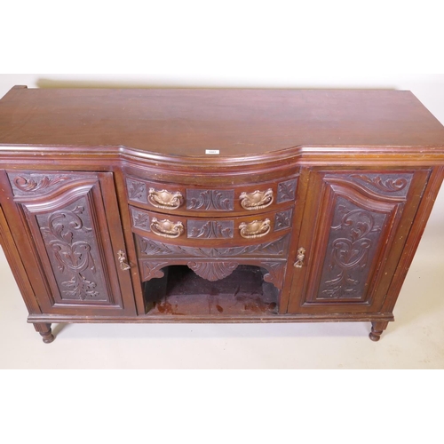 1159 - A Victorian walnut sideboard with carved decoration, two cupboards flanking two bow fronted drawers,... 