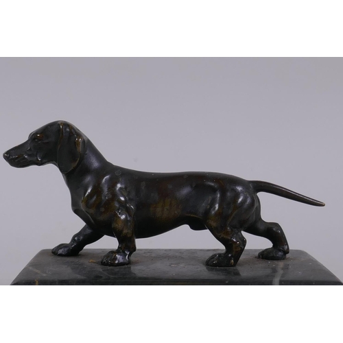 1 - An antique bronze figure of a Dachshund, on a marble base, 10cm long