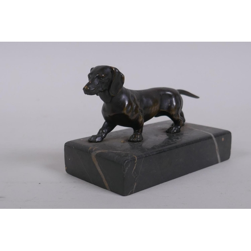 1 - An antique bronze figure of a Dachshund, on a marble base, 10cm long