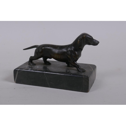 1 - An antique bronze figure of a Dachshund, on a marble base, 10cm long