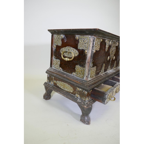 1001 - An C18th Dutch colonial teak chest with brass mounts, lift up top and two drawers, raised on claw fe... 