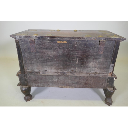 1001 - An C18th Dutch colonial teak chest with brass mounts, lift up top and two drawers, raised on claw fe... 