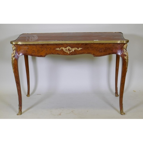 1002 - A French marquetry inlaid bureau plat, with shaped top, single drawer and ormolu mounts, bears label... 