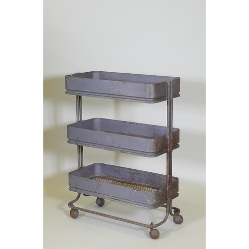 1009 - An industrial metal three tier trolley, 62 x 32cm, 85cm high