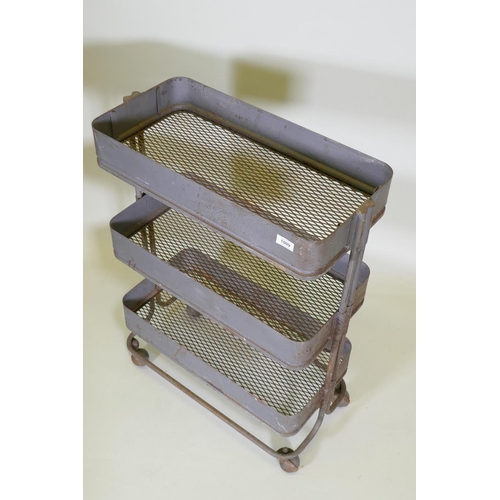 1009 - An industrial metal three tier trolley, 62 x 32cm, 85cm high