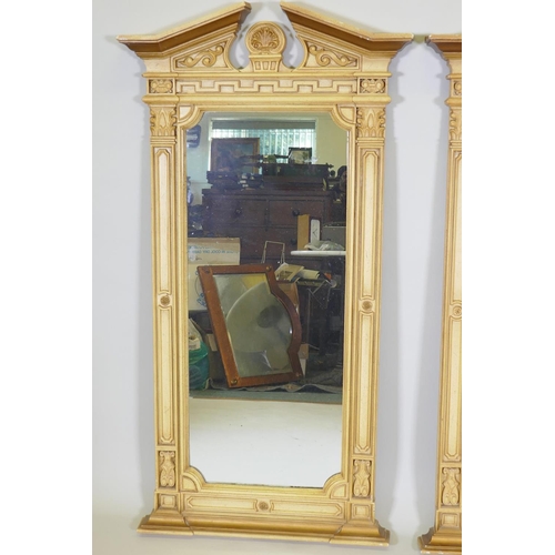 1010 - A pair of Regency style painted composition wall mirrors, with broken pediment tops and anthemion de... 