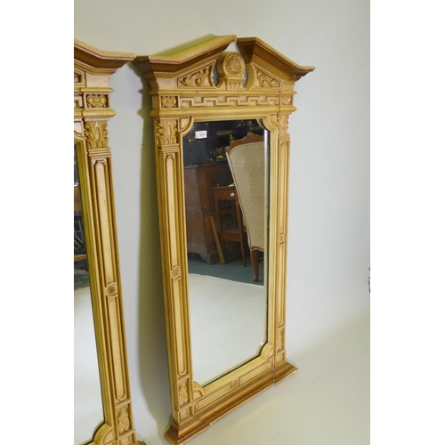 1010 - A pair of Regency style painted composition wall mirrors, with broken pediment tops and anthemion de... 