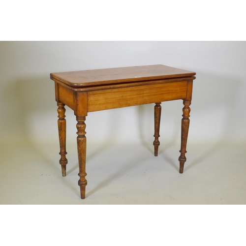 1017 - A Victorian satin walnut tea table, with fold over top, raised on turned supports, 88 x 44 x 75cm