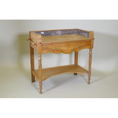 1020 - A continental elm single drawer wash stand with fitted marble three quarter gallery, raised on turne... 