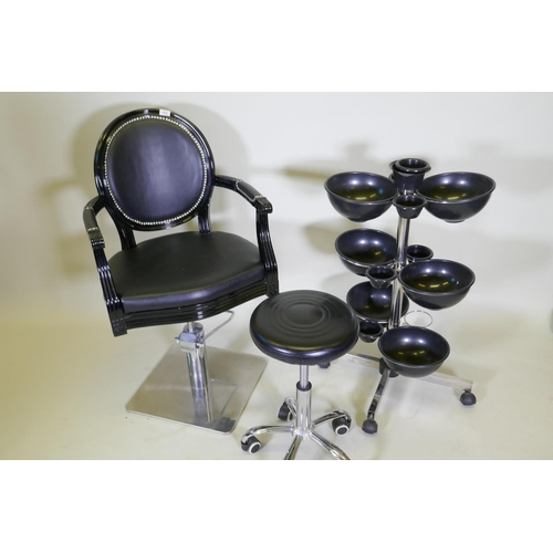 1027 - An Ayala 'Royal' hydraulic salon styling chair in black, and adjustable chrome stool on castors, and... 