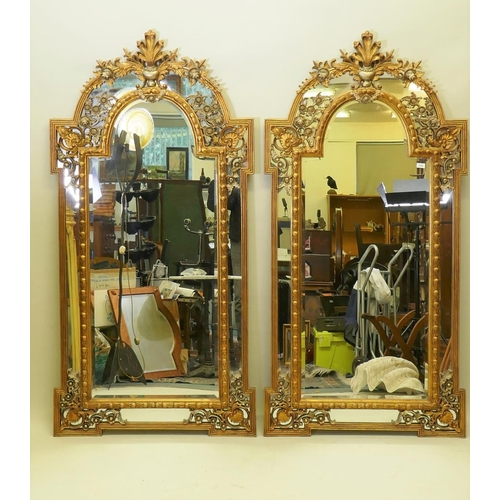 1028 - A pair of Rococo style gilt composition wall mirrors with moulded floral detail, 99 x 198cm high