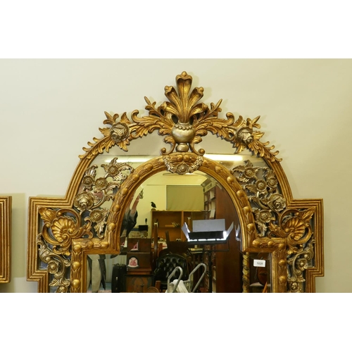 1028 - A pair of Rococo style gilt composition wall mirrors with moulded floral detail, 99 x 198cm high