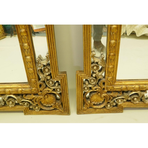 1028 - A pair of Rococo style gilt composition wall mirrors with moulded floral detail, 99 x 198cm high