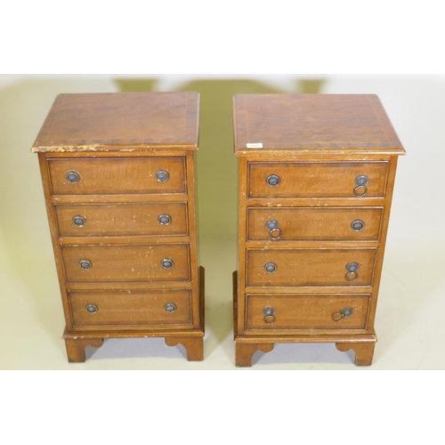 1032 - A pair of mahogany side chests of four graduated drawers with banded inlay, raised on bracket feet, ... 