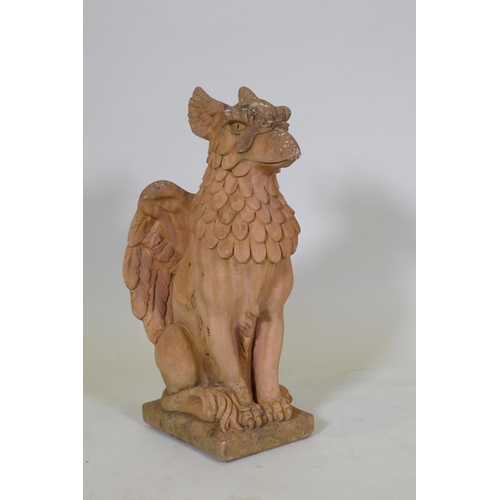 1034 - A terracotta garden figure of a griffin, 57cm high