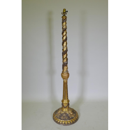 1038 - An antique gilt composition standard lamp with moulded floral and mask decoration, 150cm high