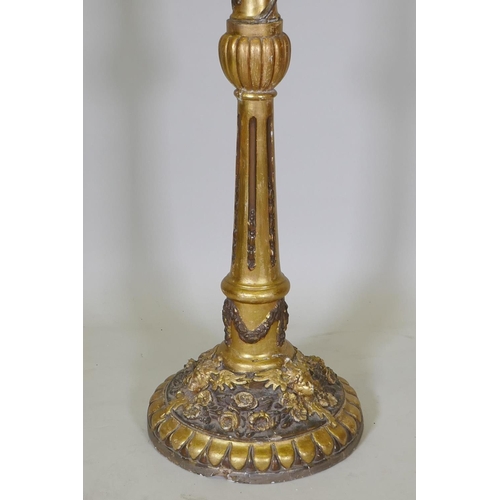 1038 - An antique gilt composition standard lamp with moulded floral and mask decoration, 150cm high