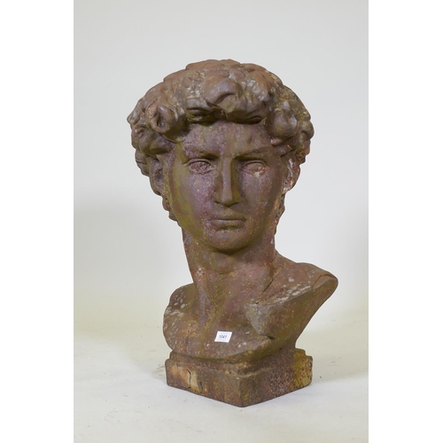 1041 - A hollow cast iron bust after Michelangelo's David, 70cm high