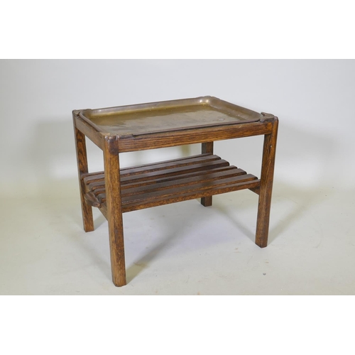 1044 - A brass and oak tray table with a slatted undertier, 64 x 49cm, 52cm high