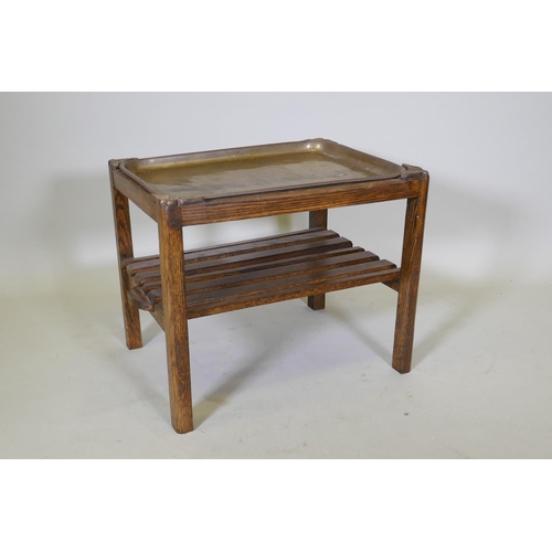 1044 - A brass and oak tray table with a slatted undertier, 64 x 49cm, 52cm high