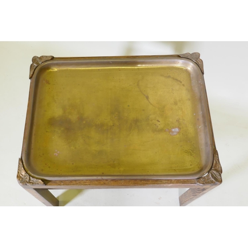 1044 - A brass and oak tray table with a slatted undertier, 64 x 49cm, 52cm high